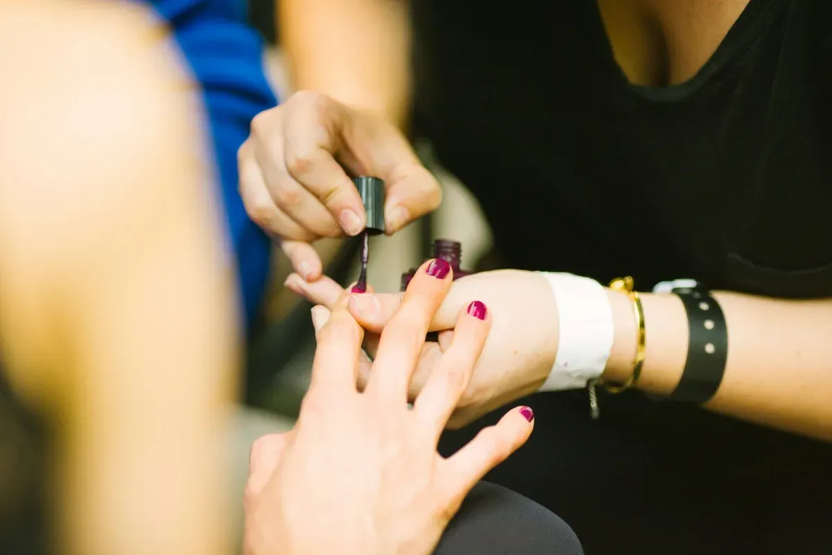 Person receiving a manicure at a salon