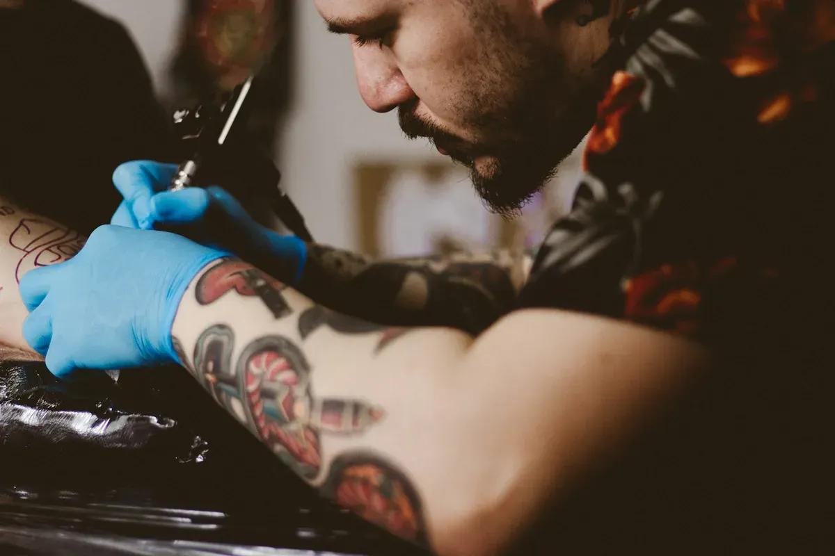 Tattoo artist working at a prepared studio station